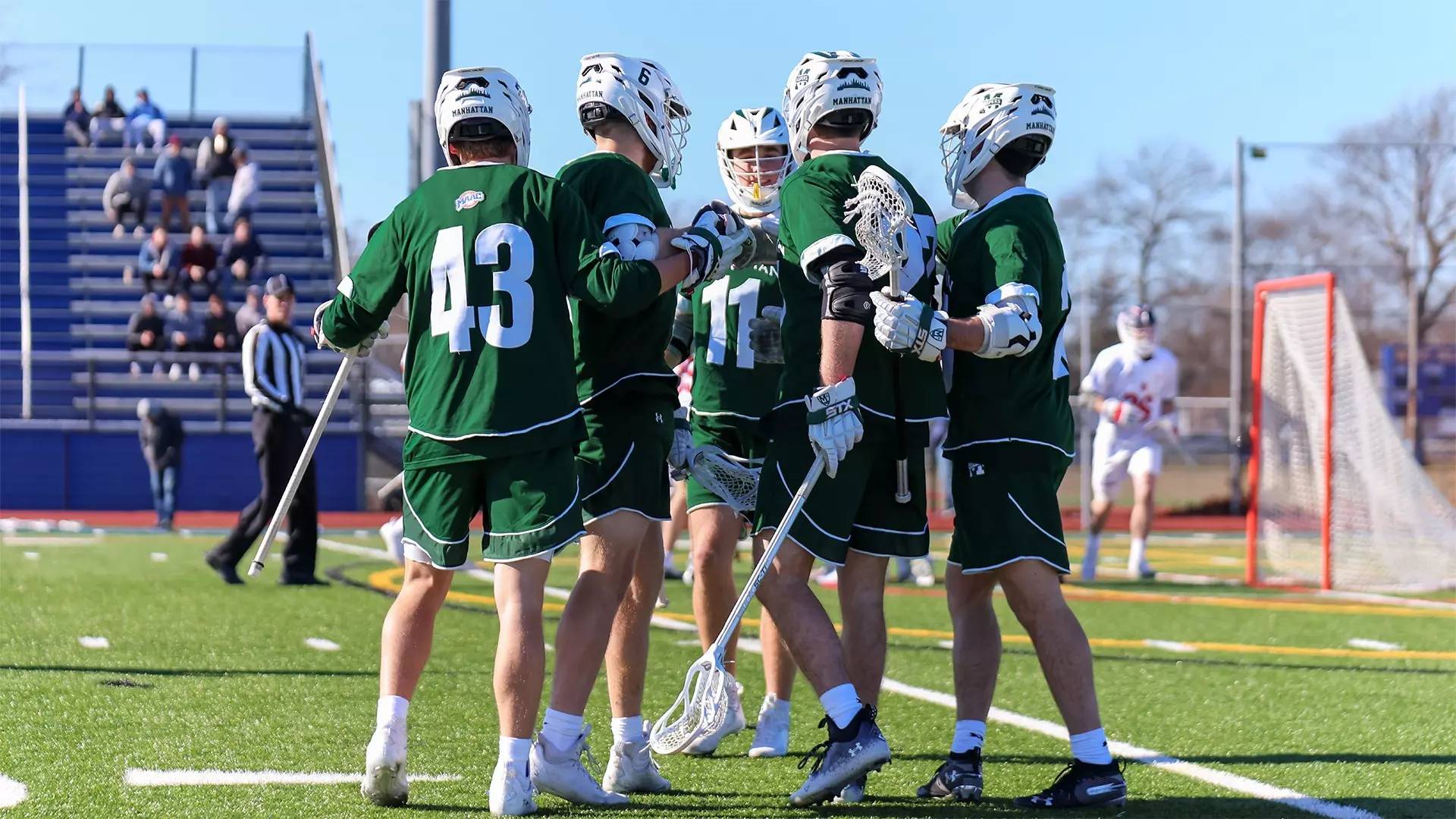 Men's lacrosse celebrates a goal against St. John's