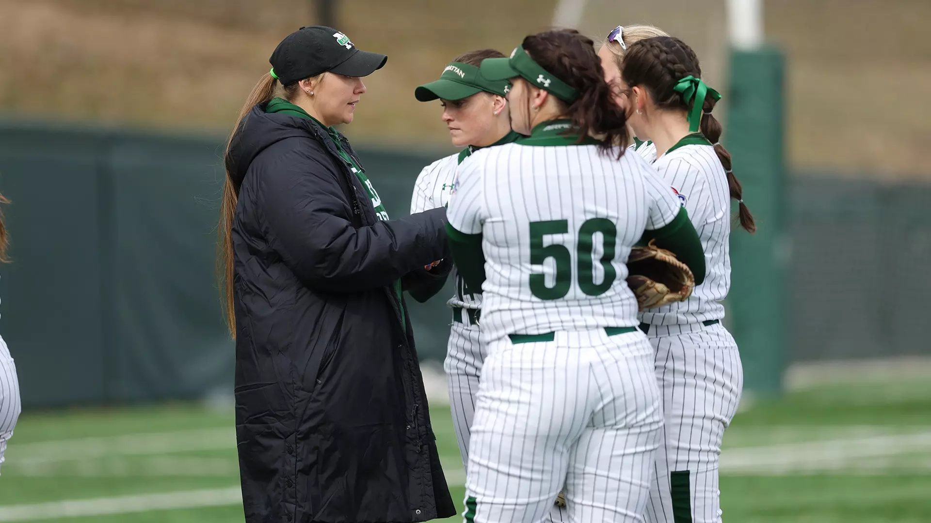 Head coach Cat Clifford visits the pitching circle 2023
