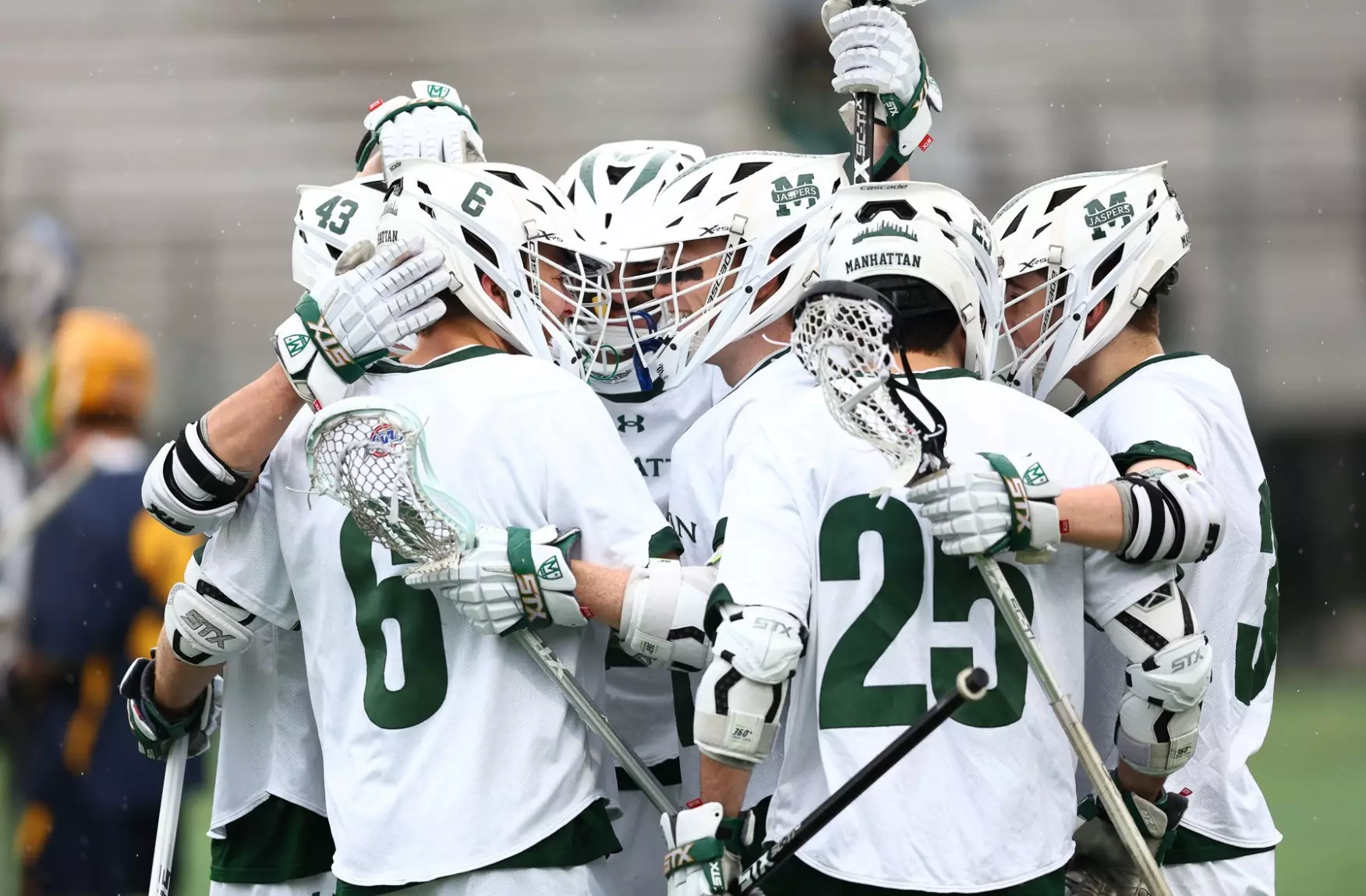 Men's lacrosse celebrates a goal vs Canisius